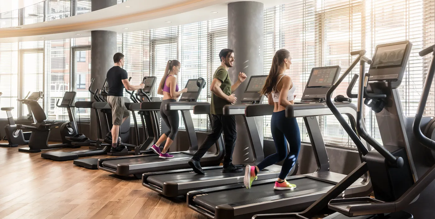People running on treadmills in a gym